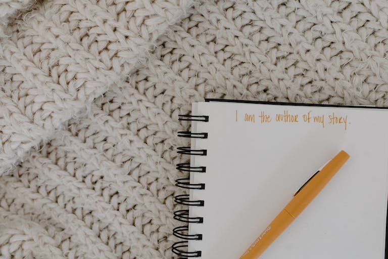 Close-Up Shot of a Pen on a Notebook